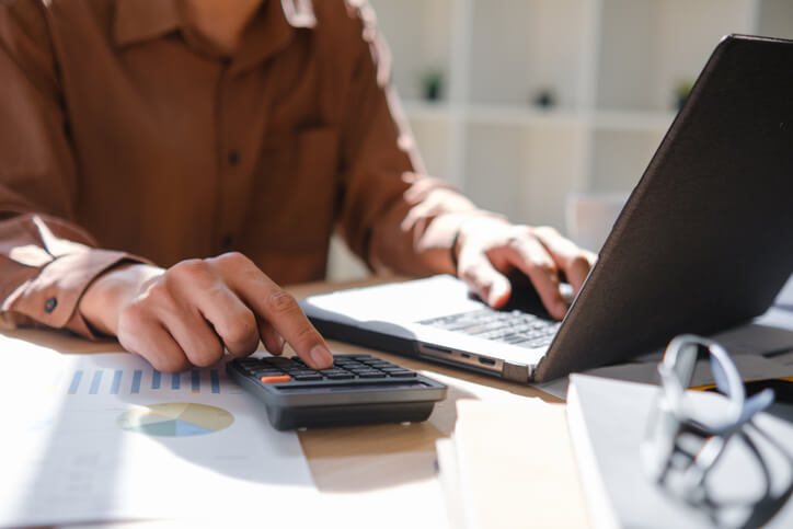 A bookkeeper organizing invoices and payroll data