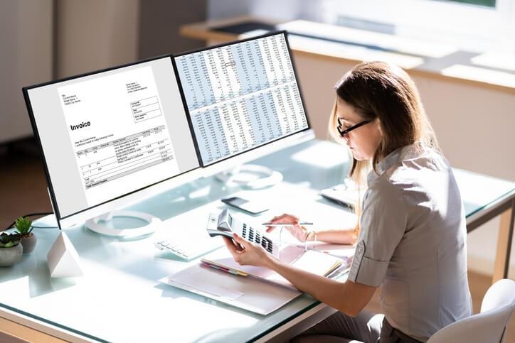 A bookkeeping professional using accounting software in a BC office